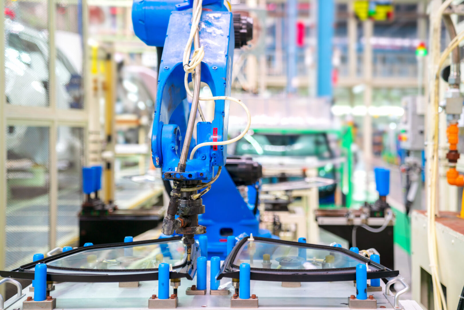 View of robot glass sealing of automation line in automotive assembly plant